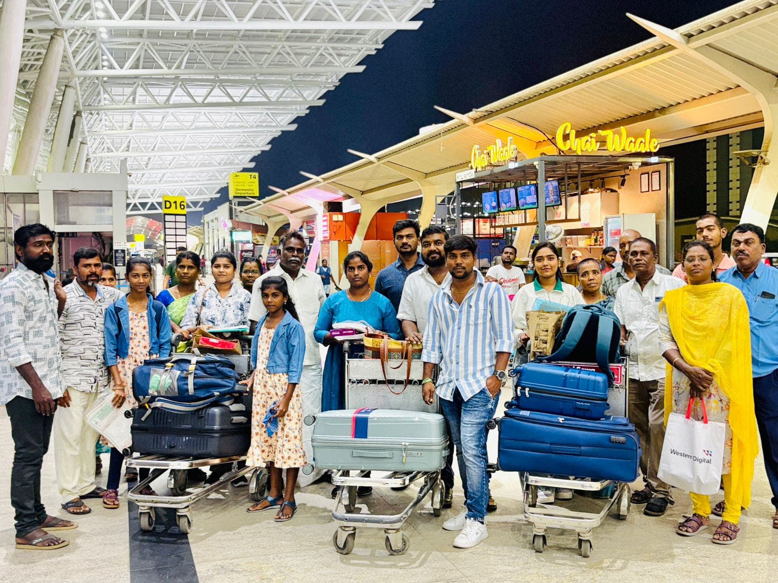 Students and families with luggage at an airport before beginning an international medical education journey